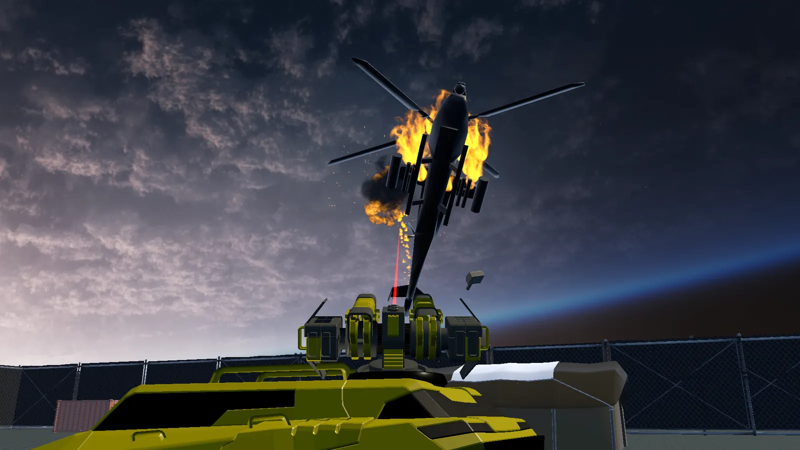 A burning helicopter falls in front of the tank's guns